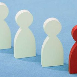 Three white pawns being led by a red pawn